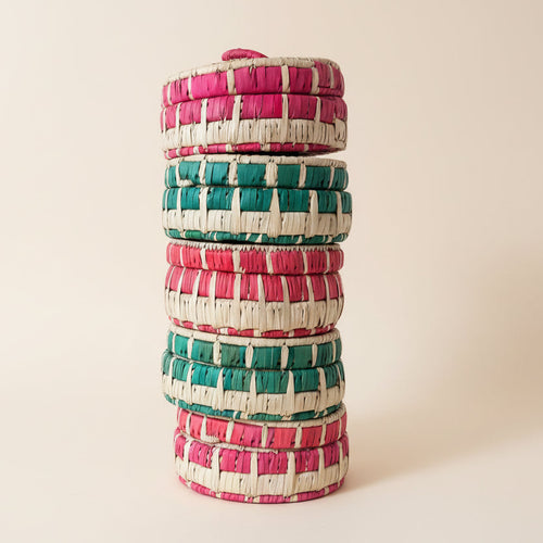 a stack of handmade baskets with lids
