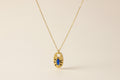 Close up of a Gold Necklace with a Blue Eye Pendant