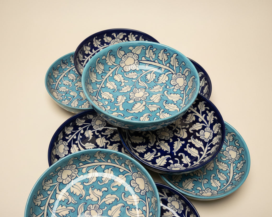 Blue handmade pottery Ceramic bowls with floral patterns on a pink background