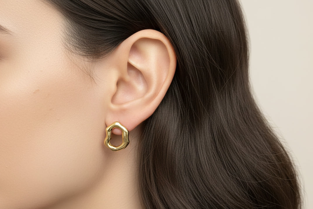 Wavy Organic Shaped earrings in gold on a model 